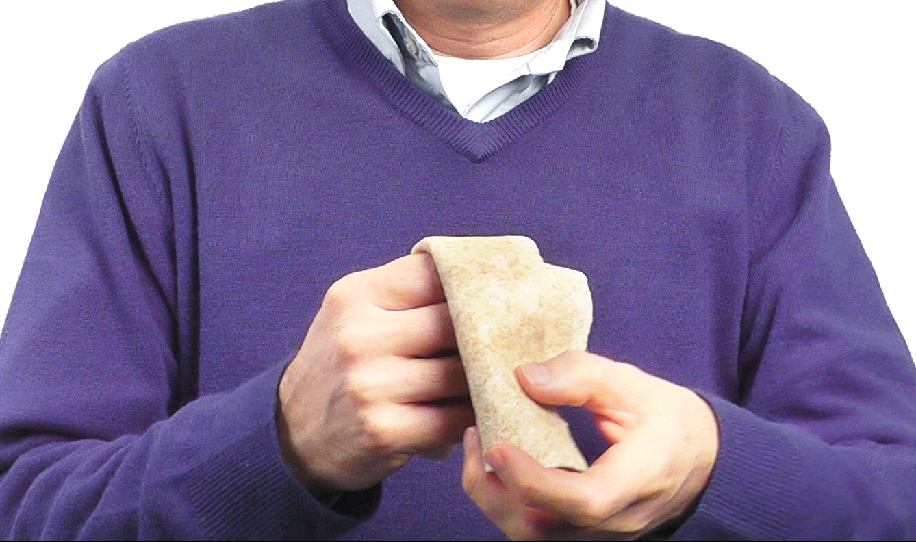 Person folding a flour tortilla bread as a sensory interaction relating to freshness